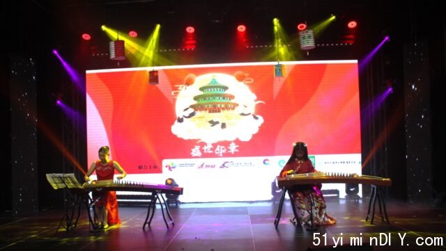 A group of women playing instruments on a stage

Description automatically generated